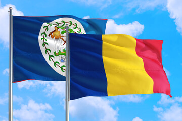 Romania and Belize national flag waving in the windy deep blue sky. Diplomacy and international relations concept.