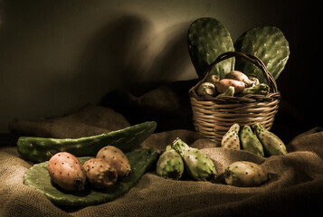 Prickly pears on a piece of jute with a wicker basket, high contrast
