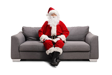 Santa claus sitting on a sofa and looking at camera