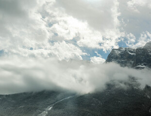 heavy clouds hang low over the rocky mountain range of Alberta Canada