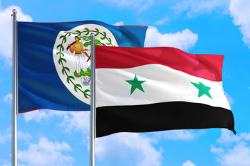 Syria and Belize national flag waving in the windy deep blue sky. Diplomacy and international relations concept.