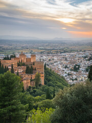 Fototapeta na wymiar The Alhambra in Granada during a sunset with beautiful views of the city at its best, articulating the landscape with incredible architecture.