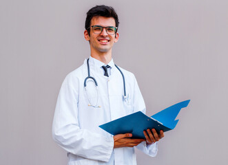 Portrait of half turn brunet hair bristle pharmacist man look at camera stand isolated on light gray background half turn make beaming toothy smile hold tablet in hands