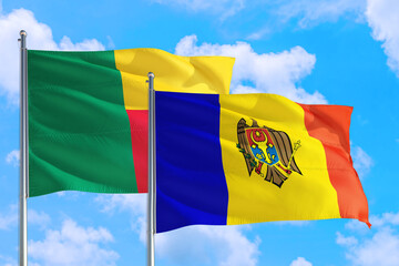 Moldova and Benin national flag waving in the windy deep blue sky. Diplomacy and international relations concept.