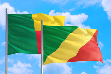 Republic Of The Congo and Benin national flag waving in the windy deep blue sky. Diplomacy and international relations concept.