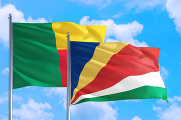 Seychelles and Benin national flag waving in the windy deep blue sky. Diplomacy and international relations concept.