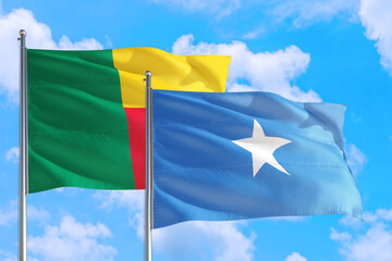 Somalia and Benin national flag waving in the windy deep blue sky. Diplomacy and international relations concept.