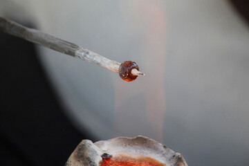 Medieval glass bead being made