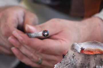 Medieval glass bead being made