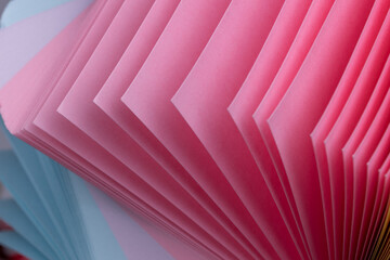 Pile of colored paper flipping effect closeup shot.