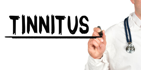 Doctor writes the word - TINNITUS. Image of a hand holding a marker isolated on a white background.