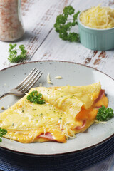 Omelette with ham and cheese on the plate