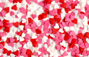 Lots of little hearts, pink, red and white. Top view, romantic background. Concept February 14.