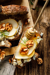 Sourdough bread sandwich with gorgonzola cheese, walnuts and honey top view