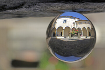 the cloister of an ancient convent reflected in a crystal ball