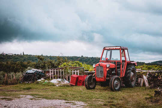 Old and run down, red tractor on a struggling farm in a small Slovenian village, Padna