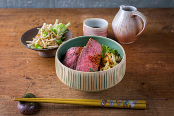 Modern style traditional Japanese ramen soup with wagyu beef filet and noodles served as close-up in a design bowl