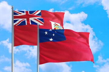 Samoa and Bermuda national flag waving in the windy deep blue sky. Diplomacy and international relations concept.