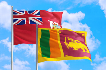 Sri Lanka and Bermuda national flag waving in the windy deep blue sky. Diplomacy and international relations concept.