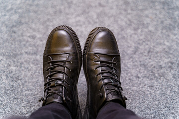 Brown boots. Leather shoes and black jeans. Man`s fashion. Selective focus.