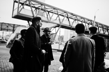 Group of handsome retro well-dressed man gangsters smoking outdoor. Multiethnic male bachelor mafia party. - obrazy, fototapety, plakaty