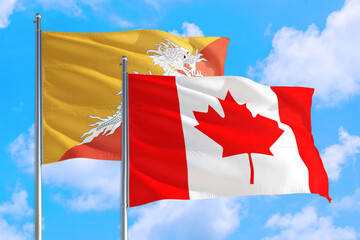 Canada and Bhutan national flag waving in the windy deep blue sky. Diplomacy and international relations concept.