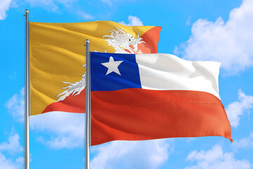 Fototapeta na wymiar Chile and Bhutan national flag waving in the windy deep blue sky. Diplomacy and international relations concept.