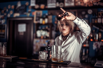 Portrait of girl tapster demonstrates his professional skills in the nightclub