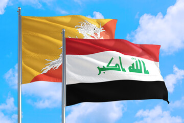 Iraq and Bhutan national flag waving in the windy deep blue sky. Diplomacy and international relations concept.