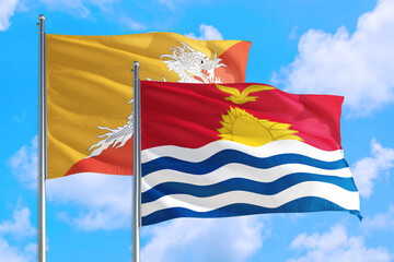 Kiribati and Bhutan national flag waving in the windy deep blue sky. Diplomacy and international relations concept.