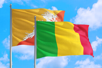 Mali and Bhutan national flag waving in the windy deep blue sky. Diplomacy and international relations concept.