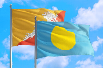 Palau and Bhutan national flag waving in the windy deep blue sky. Diplomacy and international relations concept.