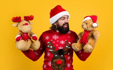 I wish. merry christmas. bearded man in santa claus costume. hipster celebrate xmas party with reindeer and bear toy. winter holiday preparations. present and gift shopping sale. happy new year