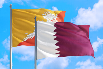 Qatar and Bhutan national flag waving in the windy deep blue sky. Diplomacy and international relations concept.