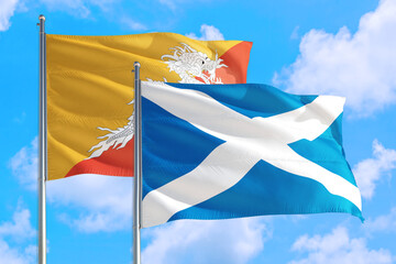 Scotland and Bhutan national flag waving in the windy deep blue sky. Diplomacy and international relations concept.
