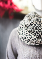 Fototapeta na wymiar A mannequin with leopard print scarf showroom with clothing fashion industry pure cashmere products organic textile, animal print scarf on a mannequin in a showroom, beautiful bokeh, copy paste concep