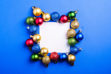 Christmas composition with white square copy space. Colorful ornament and baubles decorations. Mockup greetings card template