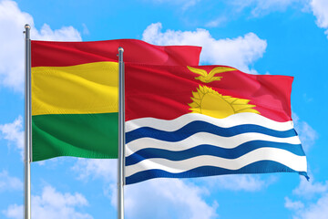 Kiribati and Bolivia national flag waving in the windy deep blue sky. Diplomacy and international relations concept.