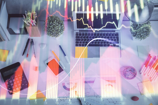 Double exposure of forex chart drawing over table background with computer. Concept of financial research and analysis. Top view. © peshkova