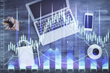 Double exposure of forex chart drawing over table background with computer. Concept of financial research and analysis. Top view.