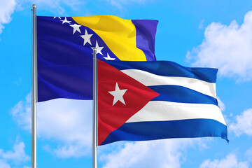 Cuba and Bosnia Herzegovina national flag waving in the windy deep blue sky. Diplomacy and international relations concept.