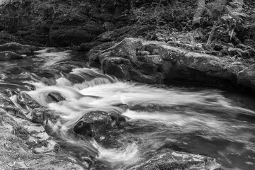 Long exposure of a waterfall on the East Lyn river flowing through the woods at Watersmeet in Exmoor National Park © tom