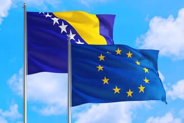 European Union and Bosnia Herzegovina national flag waving in the windy deep blue sky. Diplomacy and international relations concept.