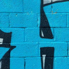 Bright Blue Big Brick Texturized Wall With Painting And Sign
