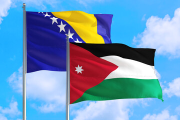 Jordan and Bosnia Herzegovina national flag waving in the windy deep blue sky. Diplomacy and international relations concept.