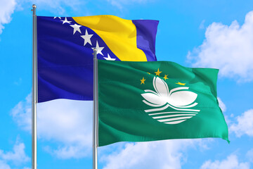 Macao and Bosnia Herzegovina national flag waving in the windy deep blue sky. Diplomacy and international relations concept.