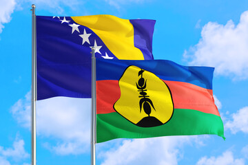 New Caledonia and Bosnia Herzegovina national flag waving in the windy deep blue sky. Diplomacy and international relations concept.