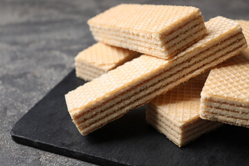 Delicious cream wafers on grey table, closeup