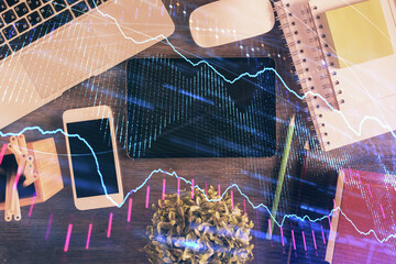 Double exposure of forex chart hologram over desktop with phone. Top view. Mobile trade platform concept.
