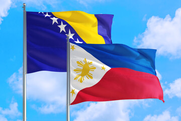 Philippines and Bosnia Herzegovina national flag waving in the windy deep blue sky. Diplomacy and international relations concept.